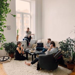 people-gathered-inside-house-sitting-on-sofa-1054974